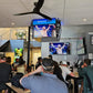 People watching sports on a jumbotron. 